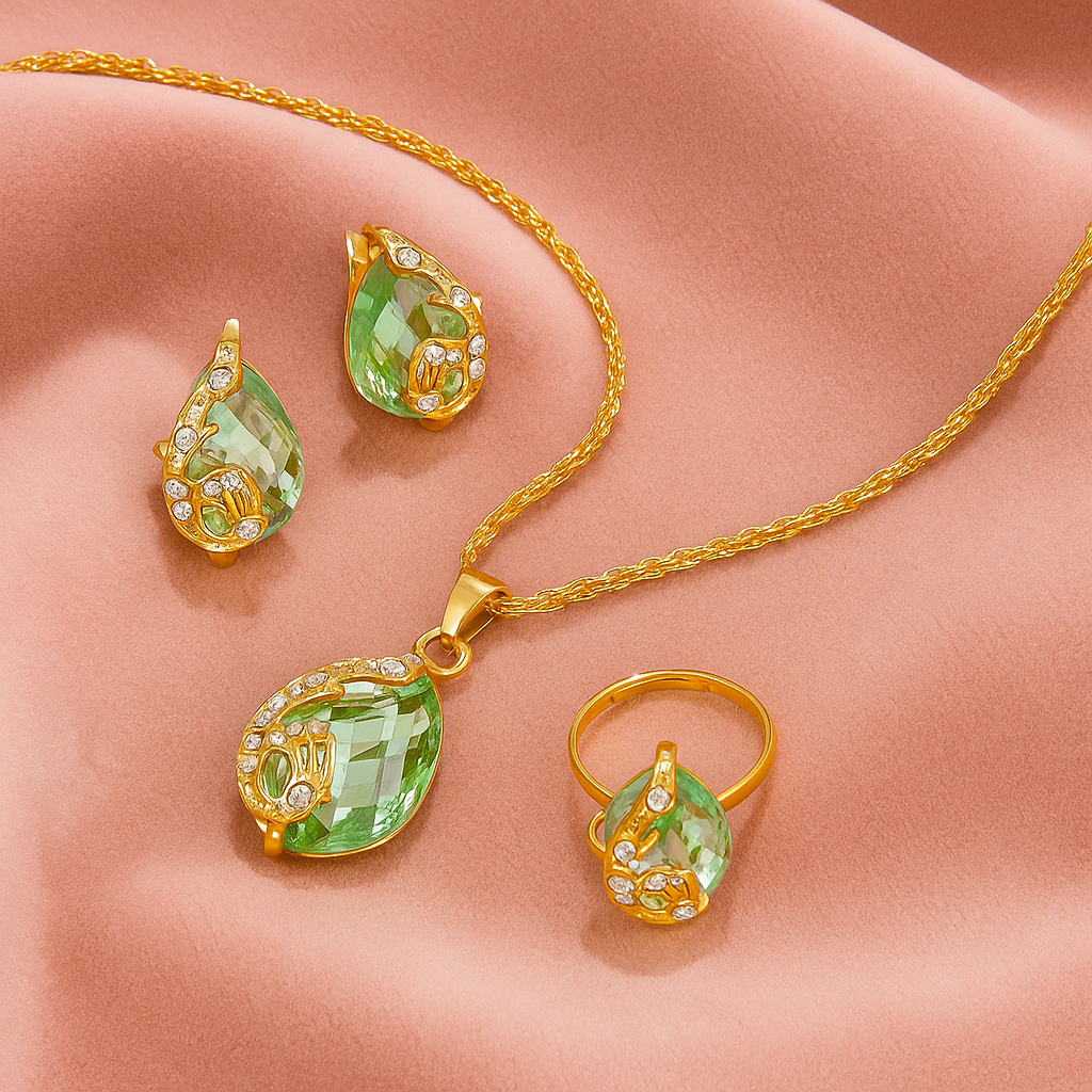 4pcs Teardrop Rhinestone Jewelry Set – Necklace, Earrings & Ring - Gold jewelry set with green teardrop-shaped gemstones on a beige surface