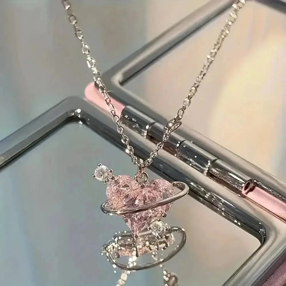 Necklace with a pink heart-shaped pendant on a reflective surface