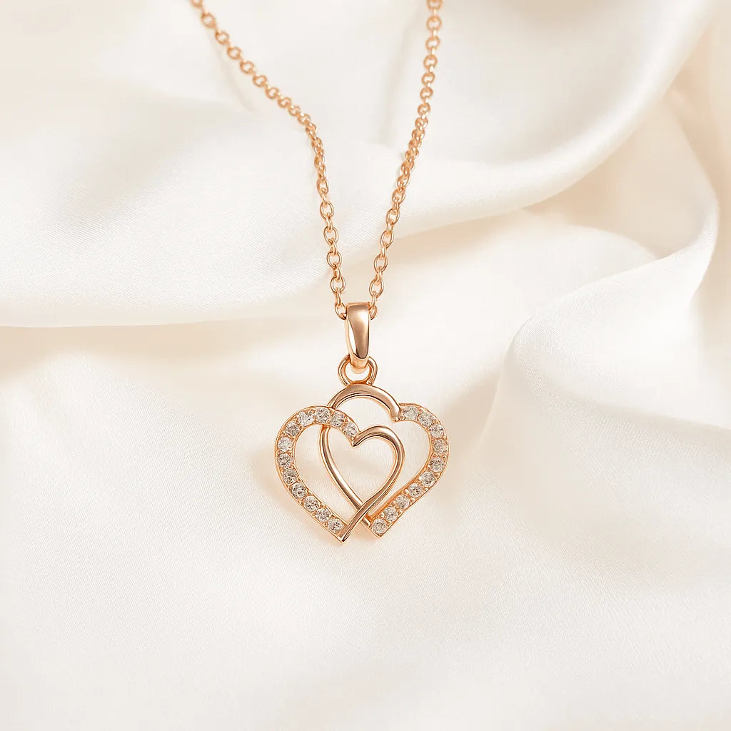Rose gold necklace with a heart-shaped pendant on a soft white background