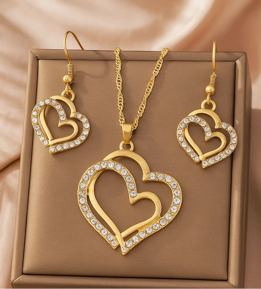 Gold heart-shaped necklace and earrings on a person - Double Heart Pendant Jewelry Set – Necklace & Earrings for Women - miraye.net