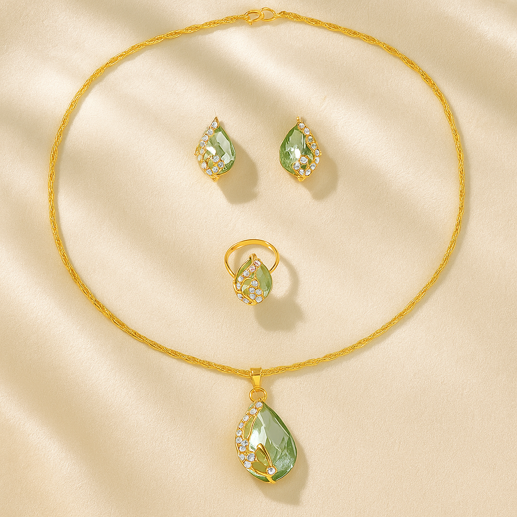 Jewelry set with necklace, earrings, and ring featuring green teardrop-shaped pendants on a beige background.