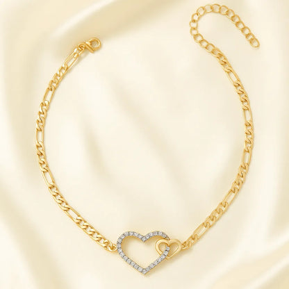 Gold bracelet with a heart-shaped clasp on a light beige background